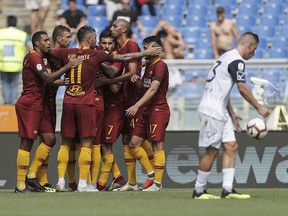 Roma players celebrate after their teammate Bryan Cristante scored during a Serie A soccer match between Roma and Chievo Verona at the Olympic Stadium in Rome, Sunday, Sept. 16, 2018.