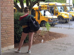 In this Sept. 7, 2018 photo, a student at Grant High School in Portland, Ore., waits for a ride after school. Portland Public Schools relaxed its dress code in 2016 after student complaints that the rules unfairly targeted female students and sexualized their fashion choices.