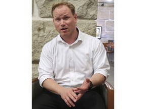 In this Tuesday, Aug. 28, 2018, photo, Steve Watkins, the Republican nominee in the 2nd Congressional District of eastern Kansas, speaks during an interview at the Statehouse in Topeka, Kan. Watkins is calling Democratic opponent Paul Davis "a safe vote" for House Democratic Leader Nancy Pelosi even though Davis is distancing himself from Pelosi.