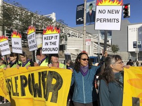 Members of the group 1000 Grandmothers protest outside the Moscone Center in San Francisco where the Global Climate Action Summit is being held, on Thursday, Sept. 13, 2018. The group, which says it is made up of elder women activists working to address the climate crisis, chanted "Listen to your Grandma, no more fracking!"