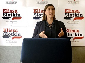 In this July 31, 2018, photo, Elissa Slotkin, a Democratic candidate for Congress from Michigan, speaks during a news conference at her campaign headquarters in Lansing, Mich. The former CIA analyst and Pentagon official is one of dozens of first-time candidates running in districts that seem to offer the best chance for flipping GOP seats this fall.