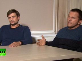 In this video grab, Ruslan Boshirov, left, and Alexander Petrov attend their first public appearance in an interview with the Kremlin-funded channel in Moscow, Russia, Thursday, Sept. 13, 2018.