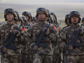 Chinese troops march at the training ground Tsugol, south-east of the city of Chita, during the military exercises Vostok 2018 in Eastern Siberia, Russia, Thursday, Sept. 13, 2018.