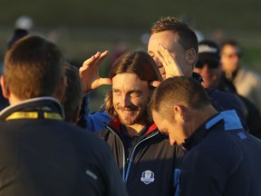 Europe's Ian Poulter, rear, jokes with Europe's Tommy Fleetwood before the European Ryder Cup team photo at Le Golf National in Guyancourt, outside Paris, France, Tuesday, Sept. 25, 2018. The 42nd Ryder Cup will be held in France from Sept. 28-30, 2018 at Le Golf National.