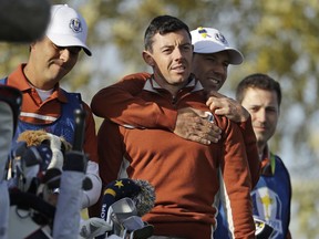 Europe's Sergio Garcia, second right, embraces Europe's Rory McIlroy on the 7th tee during a fourball match on the second day of the 42nd Ryder Cup at Le Golf National in Saint-Quentin-en-Yvelines, outside Paris, France, Saturday, Sept. 29, 2018.