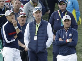 US team captain Jim Furyk, center, Jordan Spieth of the US, left, and Justin Thomas stand around the 8th green during a foursome match against Europe's Tommy Fleetwood and Europe's Francesco Molinari on the opening day of the 42nd Ryder Cup at Le Golf National in Saint-Quentin-en-Yvelines, outside Paris, France, Friday, Sept. 28, 2018.