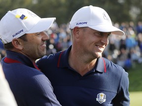 Europe's Sergio Garcia, left, and Alex Noren celebrate after winning their foursome match on the opening day of the 42nd Ryder Cup at Le Golf National in Saint-Quentin-en-Yvelines, outside Paris, France, Friday, Sept. 28, 2018. Garcia and Noren beat Phil Mickelson of the US and Bryson Dechambeau of the US 5 and 4.