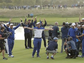 Europe's Jon Rahm, center, celebrates after Europe won the Ryder Cup on the final day of the 42nd Ryder Cup at Le Golf National in Saint-Quentin-en-Yvelines, outside Paris, France, Sunday, Sept. 30, 2018.