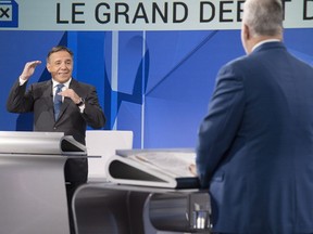 CAQ leader Francois Legault, left, questions Liberal Leader Philippe Couillard during the leaders debate Thursday, September 13, 2018 in Montreal, Que.