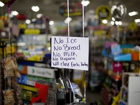 A message greets shoppers of supplies no longer available as Hurricane Florence approaches the east coast in Nichols, S.C., Thursday, Sept. 13, 2018. The residents of this tiny inland town who rebuilt after Hurricane Matthew destroyed 90 percent of the homes are uneasy as forecasters warn inland flooding from Florence's rain could be one of the most dangerous and devastating parts of the storm.