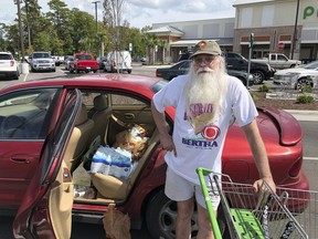 Steve Wareheim poses for a photo after making one last grocery run to prepare for Hurricane Florence at a grocery store in Ocean Isle Beach, N.C. on Wednesday, Sept. 12, 2018. Wareheim decided to ride out the storm at home after buying a generator this week.