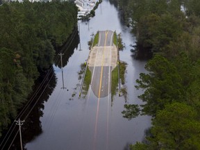 The bridge over Simpson's Creek is the only dry spot for more than a mile on S.C. Highway 905 in the Red Bluff Community in Longs, S.C. The Red Bluff community has flooded along the Waccamaw River and Simpsons Creek from Hurricane Florence's deluge with entire neighborhoods underwater.