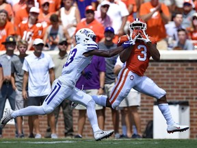 Clemson's Amari Rodgers pulls in a reception for a touchdown while defended by Furman's Quandarius Weems during the first half of an NCAA college football game Saturday, Sept. 1, 2018, in Clemson, S.C.