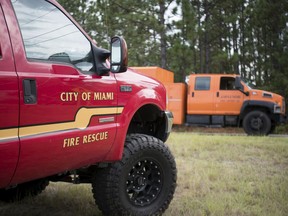 A utility truck passes a vehicle from a special operations rescue team from Miami,  outside the South Carolina National Guard Readiness Center as Hurricane Florence prepares for landfall on the East Coast Thursday, Sept. 13, 2018, in West Columbia, S.C.