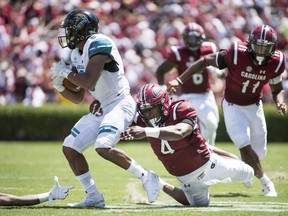 South Carolina linebacker Bryson Allen-Williams (4) wraps up Coastal Carolina wide receiver Malcolm Williams (9) during the first half of an NCAA college football game Saturday, Sept. 1, 2018, in Columbia, S.C.