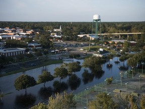 Floodwaters surround tennis courts after Hurricane Florence struck the Carolinas Monday, Sept. 17, 2018, in Conway, S.C.