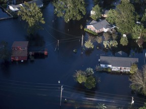 Floodwaters inundate homes after Florence struck the Carolinas, Monday, Sept. 17, 2018, in Conway, S.C.