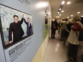 A photo, from the April 27, 2018, inter-Korean summit between South Korean President Moon Jae-in and North Korean leader Kim Jong Un, left, is displayed at the Unification Observation Post in Paju, near the border with North Korea, South Korea, Sunday, Sept. 16, 2018. Moon is to fly to Pyongyang, North Korea, next Tuesday, Sept. 18, for a three-day trip that he says will focus on facilitating talks between the United States and North Korea and finding ways to ease a military standoff along the Koreas' heavily fortified border.