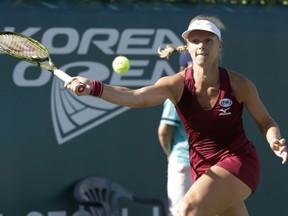 Kiki Bertens of the Netherlands returns a shot to Maria Sakkari of Greece during their semifinal match at the Korea Open tennis championship in Seoul, South Korea, Saturday, Sept. 22, 2018.