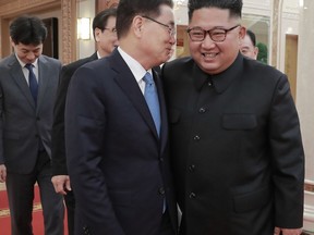 In this Wednesday, Sept. 5, 2018 photo provided on Thursday, Sept. 6, 2018 by South Korea Presidential Blue House via Yonhap News Agency, North Korean leader Kim Jong Un, right, talks with South Korean National Security Director Chung Eui-yong in Pyongyang, North Korea. A South Korean delegation met with North Korean leader Kim Jong Un on Wednesday during a visit to arrange an inter-Korean summit planned for this month and help rescue faltering nuclear diplomacy between Washington and Pyongyang. (South Korea Presidential Blue House/Yonhap via AP)