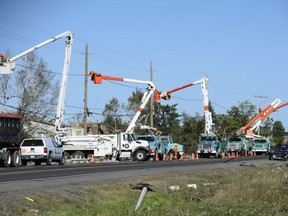 Hydro crews work to restore power following a tornado in Dunrobin, Ont., west of Ottawa, on Monday, Sept. 24, 2018. The tornado that hit the area was on Friday, Sept, 21.