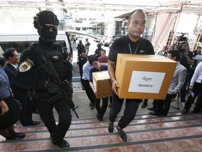 Thai policemen guard next to 100 kilograms of seized marijuana before a news conference Bangkok, Thailand, Tuesday, Sept. 25, 2018. Thai police handed over around 100 kilograms of seized marijuana to be used for medical research Tuesday, as officials seek to produce pot-based medication.