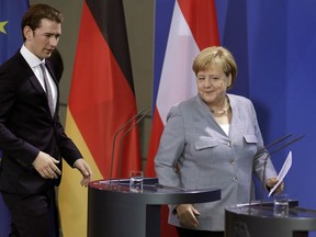 German Chancellor Angela Merkel, right, and the Chancellor of Austria, Sebastian Kurz, arrive for a statement prior to a meeting at the chancellery in Berlin, Germany, Sunday, Sept. 16, 2018.