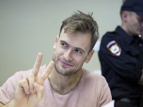 In this Monday, July 23, 2018 file photo, Pyotr Verzilov, a member of the feminist protest group Pussy Riot, gestures during hearings in a court in Moscow, Russia.