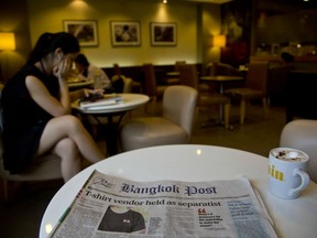 Thailand's Bangkok Post newspaper depicting a cover story on detention of a vender who sold black t-shirts, bearing a symbol allegedly linked to a movement promoting a federal republic, is placed on a table at a cafeteria in Bangkok, Thailand, Tuesday, Sept. 11, 2018. Thailand's military government this past week launched a crackdown on a small anti-government movement advocating a federal republic, arresting its alleged sympathizers on the basis of their owning t-shirts bearing the group's logo of a tiny red and white flag.
