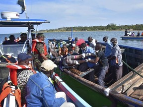 Rescuers retrieve a body from the water near Ukara Island in Lake Victoria, Tanzania Friday, Sept. 21, 2018. The death toll rose above 100 after the passenger ferry MV Nyerere capsized on Lake Victoria, Tanzania state radio reported Friday, while a second day of rescue efforts raced the setting sun.