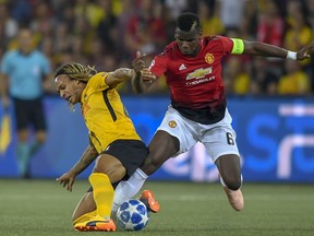 Young Boys' Kevin Mbabu, left, fights for the ball against Manchester United's Paul Pogba, right, during the Champions League group H soccer match between Young Boys and Manchester United at the Stade de Suisse in Berne, Switzerland, Wednesday, Sept. 19, 2018.