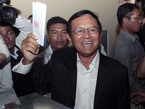 FILE - In this June 4, 2017, file photo, then opposition Cambodia National Rescue Party President Kem Sokha shows off his ballot before voting in local elections in Chak Angre Leu on the outskirts of Phnom Penh, Cambodia. A Cambodian government spokesman says Kem Sokha who has been held been for a year on a treason charge, was released on bail Monday, Sept. 10, 2018.