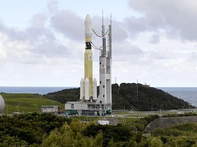 In this Sept. 14, 2018, photo, an H-2B rocket carrying the Kounotori 7 cargo spacecraft is seen at Tanegashima Space Center in the southwestern Japan prefecture of Kagoshima.  The Japanese supply run to the International Space Station has been delayed again. The countdown was halted Saturday, Sept. 15, in Japan, with only a few hours remaining before liftoff. Earlier in the week, a typhoon delayed the launch.(Kyodo News via AP)
