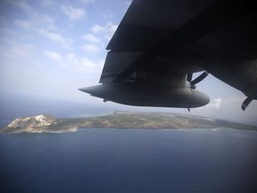 FILE - In this March 21, 2015, file photo, Iwo Jima, now known officially as Ioto, is seen from an airplane in Japan. Japan's Meteorological Agency said Wednesday, Sept. 12, 2018, aerial photos detected signs of undersea volcanic eruptions off the southern coast of Iwo Jima, the site of one of the bloodiest campaigns in the World War II.