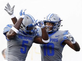 Memphis receiver Damonte Coxie, right, celebrates a touchdown against Georgia State with teammate Sean Dykes during NCAA college football action in Memphis, Tenn., Friday, Sept. 14, 2018.