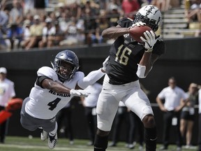 Vanderbilt wide receiver Kalija Lipscomb (16) catches a 2-yard touchdown pass ahead of Nevada defensive back EJ Muhammad (4) in the first half of an NCAA college football game Saturday, Sept. 8, 2018, in Nashville, Tenn.