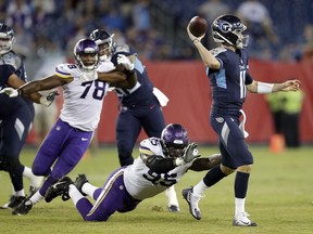 Tennessee Titans quarterback Luke Falk (11) passes as he is pressured by Minnesota Vikings defensive end Ifeadi Odenigbo (95) in the second half of a preseason NFL football game Thursday, Aug. 30, 2018, in Nashville, Tenn.