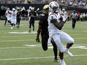 CORRECTS DATE South Carolina wide receiver Shi Smith (13) catches a 38-yard pass for a touchdown in front of Vanderbilt defensive back Allan George (28) in the first half of an NCAA college football game Saturday, Sept. 22, 2018, in Nashville, Tenn.