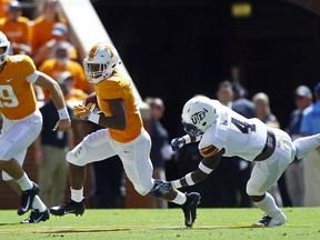Tennessee running back Ty Chandler (8) runs away from UTEP defensive back Broderick Harrell (4) as quarterback Keller Chryst (19) trails during the first half of an NCAA college football game Saturday, Sept. 15, 2018, in Knoxville, Tenn.