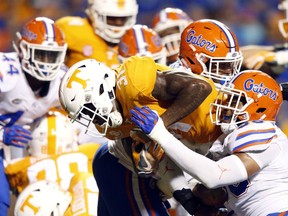 Tennessee running back Madre London (31) tries to score as he's stopped by Florida defensive lineman Tedarrell Slaton (56) in the second half of an NCAA college football game Saturday, Sept. 22, 2018, in Knoxville, Tenn.