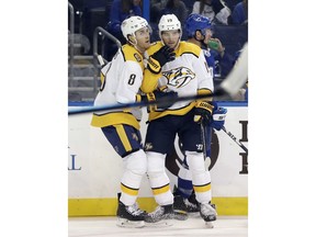 Nashville Predators center Calle Jarnkrok (19) celebrates with center Kyle Turris (8) after scoring against the Tampa Bay Lightning during the first period of an NHL preseason hockey game Saturday, Sept. 22, 2018, in Tampa, Fla.