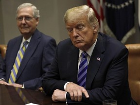 U.S. President Donald Trump, right, listens during a meeting with Republican Congressional Leadership in the Roosevelt Room of the White House in Washington, D.C., U.S., on Wednesday, Sept. 5, 2018.
