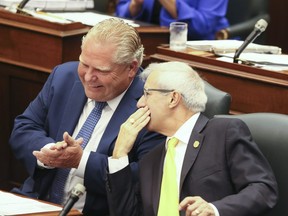 Premier Doug Ford (L) and Finance Minister Vic Fedeli during question period as the conservative party plans to pass a bill to reduce Toronto city council by nearly half on Monday September 17, 2018.
