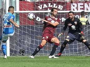 Napoli's Lorenzo Insigne, left, scores during a Serie A soccer match between Torino and Napoli at the Olympic stadium, in Turin, Italy, Sunday, Sept. 23, 2018.