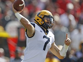 West Virginia's Will Grier (7) throws down field during the first half of an NCAA college football game against Texas Tech, Saturday, Sept. 29, 2018, in Lubbock, Texas.