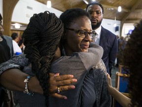Allison Jean embraces hers son's friends following a prayer vigil for Botham Shem Jean at the Dallas West Church of Christ on Saturday, Sept. 8, 2018 in Dallas. He was shot by a Dallas police officer in his apartment on Thursday night.
