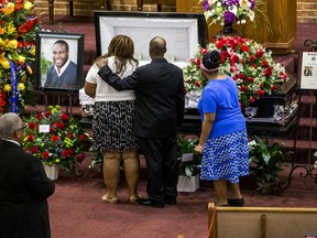 Mourners console each other during the public viewing before the funeral of Botham Shem Jean at the Greenville Avenue Church of Christ on Thursday, September 13, 2018 in Richardson, Texas. He was shot and killed by a Dallas police officer in his apartment last week in Dallas.
