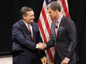 Republican U.S. Senator Ted Cruz, left, and Democratic U.S. Representative Beto O'Rourke, right, shake hands before their first debate for the Texas U.S. Senate in Dallas, Friday Sept. 21, 2018.