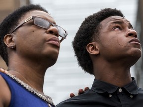 Brandt Jean, brother of Botham Jean, stands next to his mother, Allison Jean, during a press conference on Monday, Sept. 10, 2018, at the Frank Crowley Courts Building in Dallas. Botham Jean was shot and killed by Dallas police officer Amber Guyger in his apartment on Thursday night.