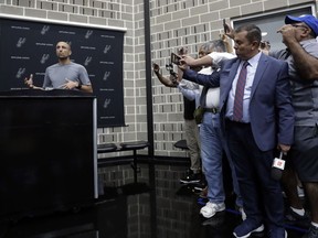 Former San Antonio Spurs guard Manu Ginobili, left, talks to the media at the NBA basketball team's practice facility, Saturday, Sept. 15, 2018, in San Antonio. Ginobili recently retired at age 41 after 16 seasons with the Spurs and helping them win four NBA championships.